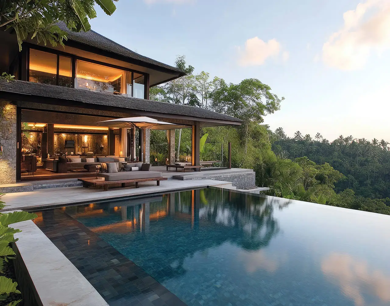 Luxurious modern villa with open-concept living space and an infinity pool overlooking lush tropical forest – showcasing Neworld’s premium eco-resort-style living.