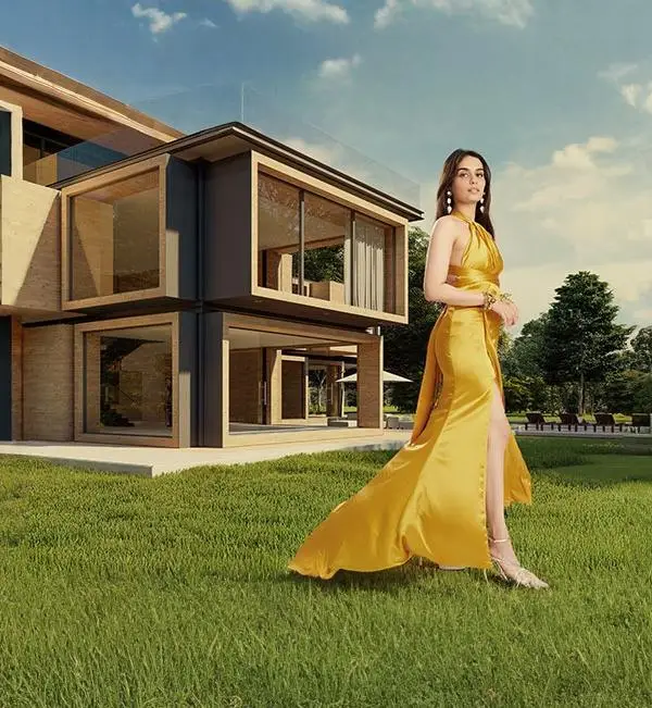 Luxury real estate promotion by Neworld Developers featuring a modern villa and an elegantly dressed woman in a golden gown, symbolizing premium lifestyle and elegance.